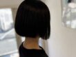 黒髪のコンパクトボブを斜め後ろから見た仕上がり。なめらかな毛流れとすっきりした襟足まわり
